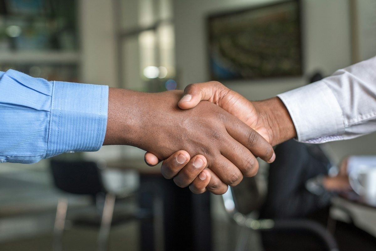 Two business professionals shaking hands representing a partnership
